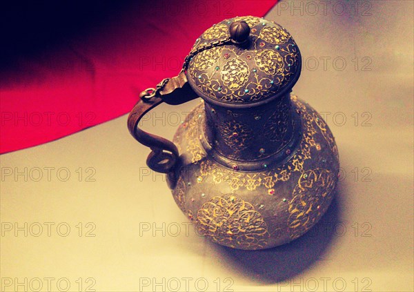 Very old style metal ewer water jar in view