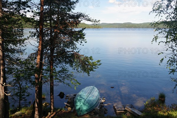Small boat lying on a deserted lake