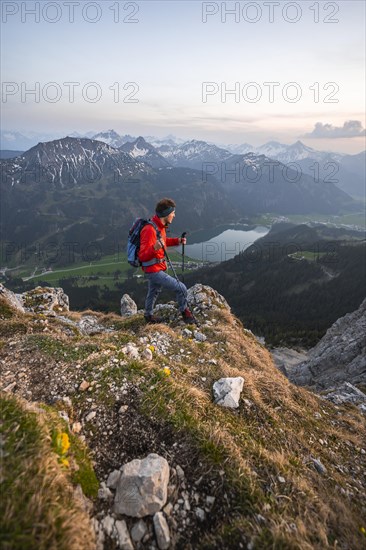 Hiker at the summit of Schartschrofen at sunset