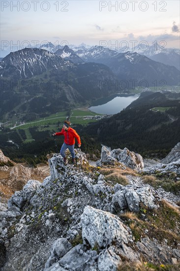Hiker at the summit of Schartschrofen at sunset