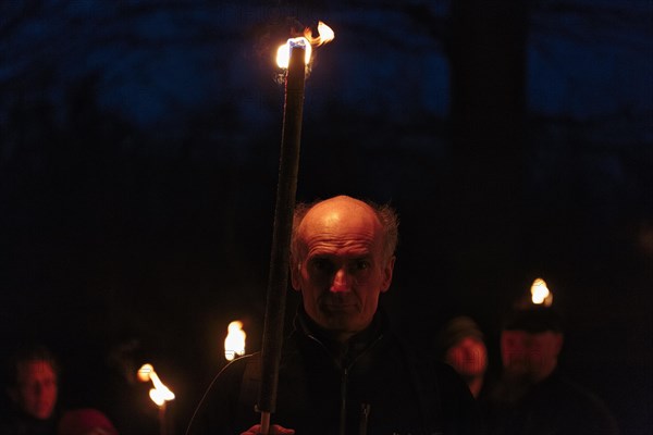 Walkers with torches at night