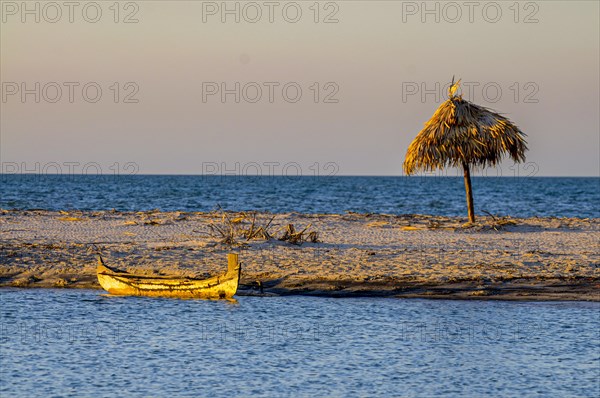 Little sailing boat on a sand tongue below the Antsanitia beach resort near Mahajanga