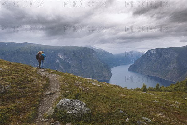 Two woman look from the mountain over the Aurlandsfjord in Norway