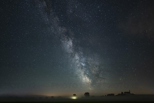 Church of St. Alban with village of Goerwangs and Milky Way with starry sky