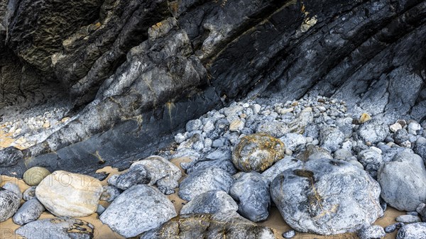 Rocky coast and colourful stones at Praia da Adraga