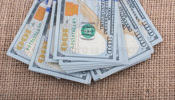Banknote bundle of US dollar placed on a linen canvas