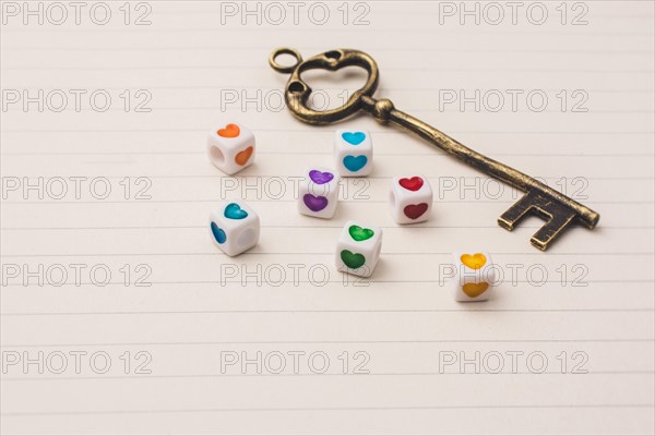 Key and colorful cubes with a heart placed on paper