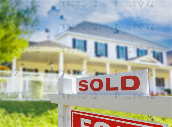 Sold for sale real estate sign in front of new house