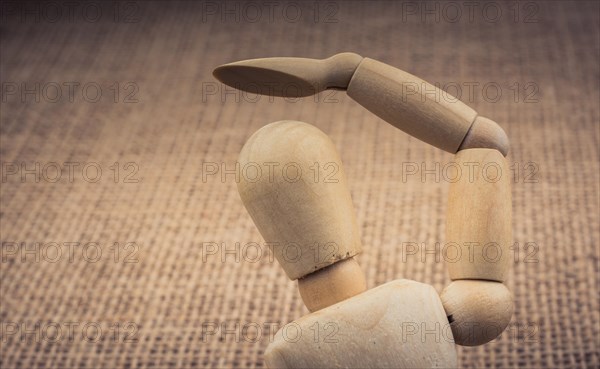 Wooden dolls of a man posing on canvas