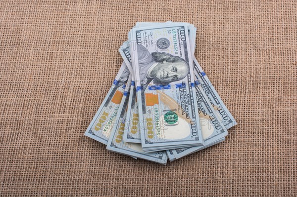 Banknote bundle of US dollar placed on a linen canvas