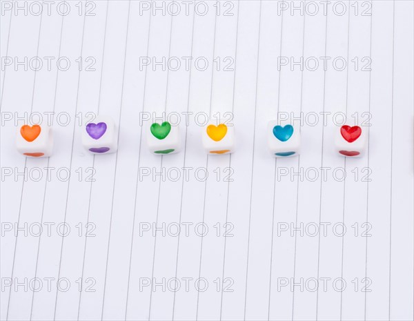 Love cubes and paper arrow on a notebook