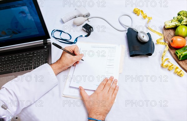 Top view of nutritionist writing on notepad. Concept of nutritionist taking notes on prescription
