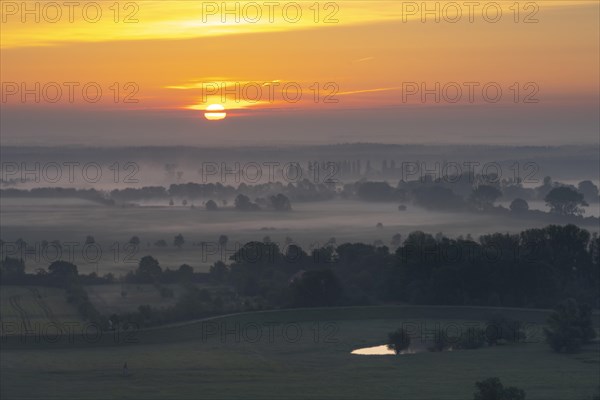 View from the Kniepenberg lookout tower of sunrise and morning fog in the Lower Saxony Elbe floodplain near Neu Darchau