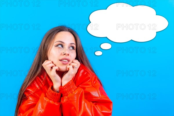 Thinking woman with many ideas with empty bubble on blue background