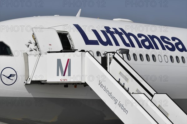 Lufthansa aircraft with passenger stairs on the east apron in front of Terminal 2
