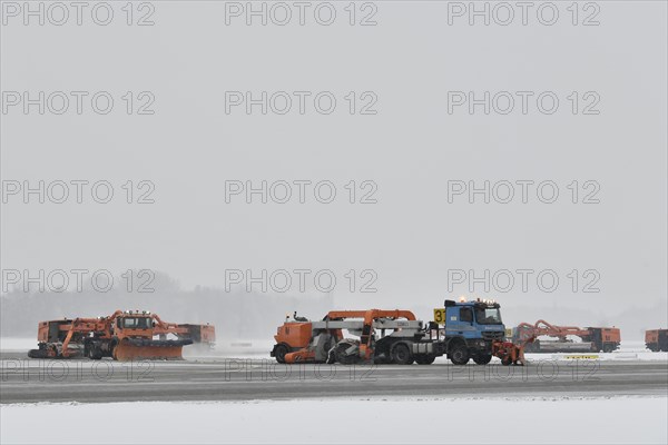 Road sweepers and snow ploughs clear snow on the taxiways and Runway North