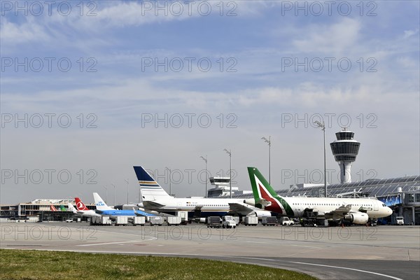 Aircraft on check-in position at Terminal 1 with tower