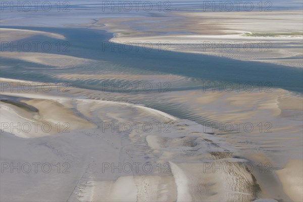 Aerial view of estuary on tidal mud flat at the Schleswig-Holstein Wadden Sea National Park