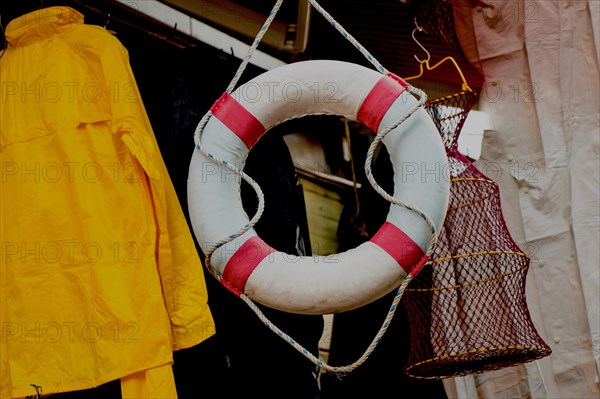 Lifesaver or life preserver with rope around for a drowning person to grab