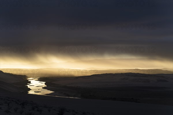 Thunderstorm over the Orange River, also known as the Orange River, on the border between Namibia and South Africa, Oranjemund, Sperrgebiet National Park, also known as Tsau ÇKhaeb National Park, Nam...
