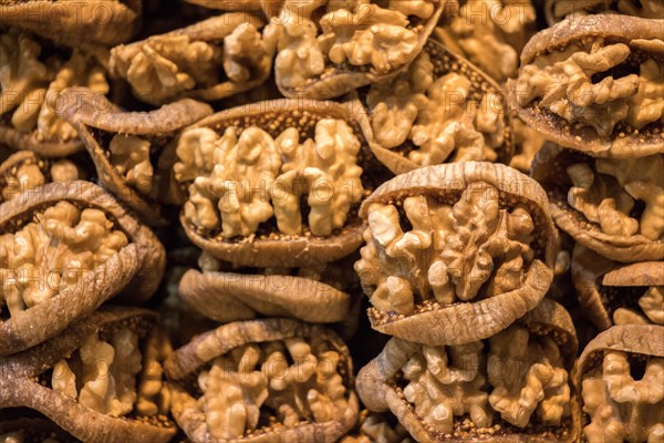 Pile of whole fresh walnuts without nutshells in fig
