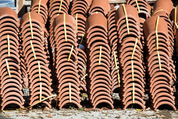 Pile of roofing tiles as a construction material at a building suppliers