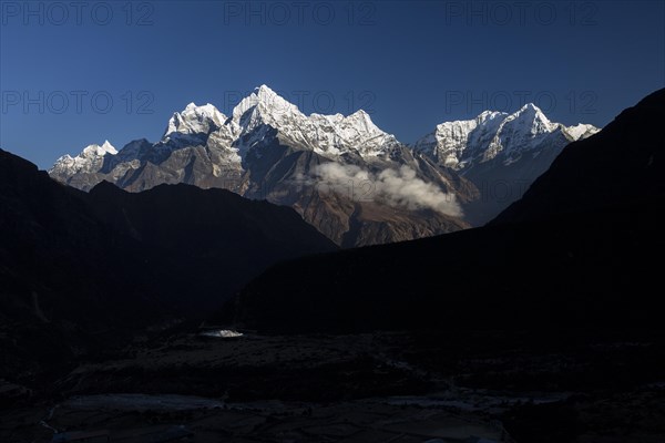 Mountain panorama seen from Thame village on an autumn evening with some high Himalayan peaks, including Malanphulan, Kangtega, Thamserku, Kusum Kanguru. Three Passes Trek. Khumbu, the Everest Region,...