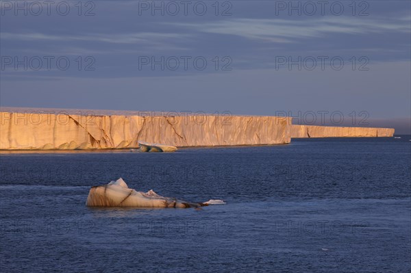 Brasvellbreen coastal glacier, glacier front in the evening light at sunset, ice chunks floating in front of it, Nordaustlandet, Svalbard