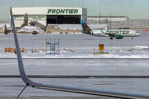 Denver, Colorado, A Frontier Airlines jet on the ground after a snowstorm at Denver International Airport