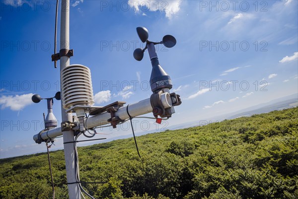 A cup cross anamometer for recording wind speed and hygrometers for recording air temperature and relative humidity hang from a measuring tower of the Northwest German Forest Research Institute above ...
