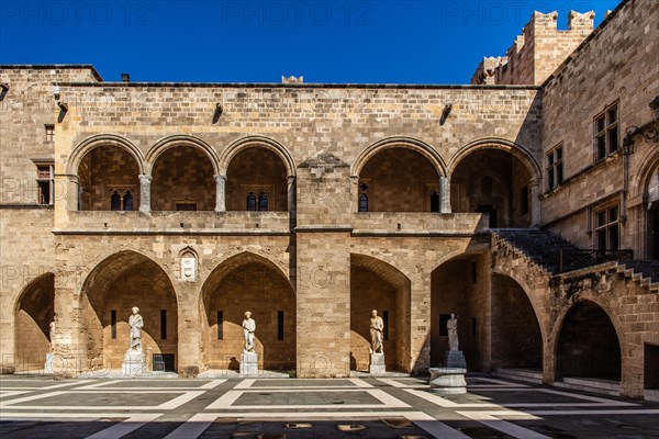 Inner courtyard surrounded by arcades with statues from Hellenistic and Roman times, Grand Masters Palace built in the 14th century by the Johnnite Order, fortress and palace for the Grand Master, UNE...
