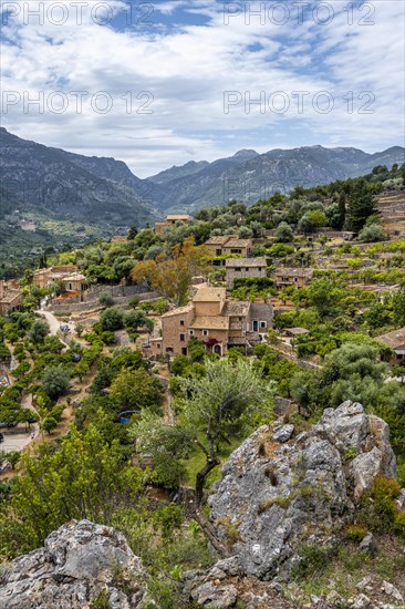 View of typical houses of the mountain village Fornalutx with mountain landscape