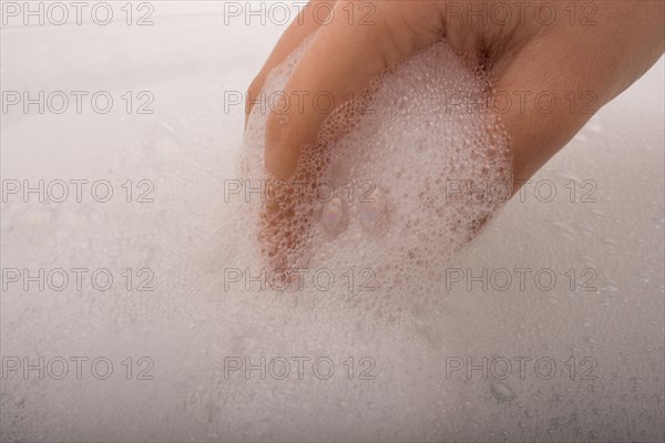 Hand washing and soap foam on a foamy background