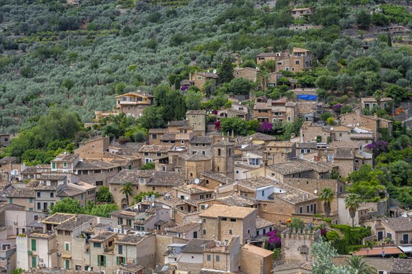 View of typical houses of the mountain village Fornalutx with church Parroquia catolica La Natividad de la virgen Maria