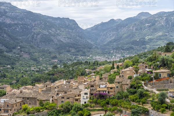 View over typical houses of the mountain village Fornalutx with mountain landscape