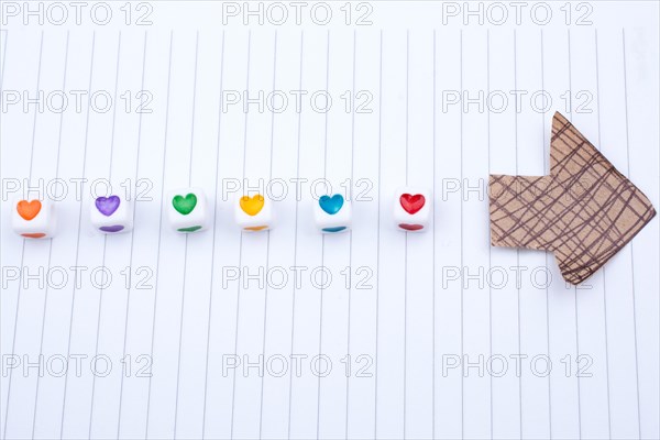 Love cubes and paper arrow on a notebook