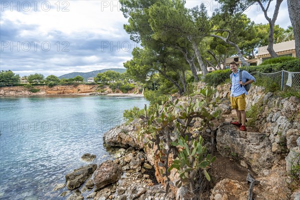 Tourist at a small rocky bay with blue sea