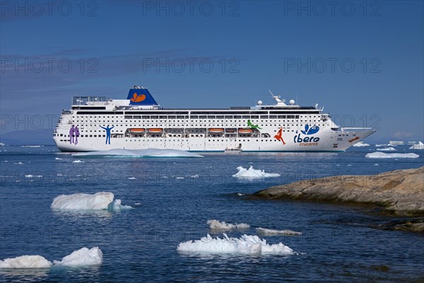 The Grand Mistral cruise ship among icebergs in the Kangia Icefjord