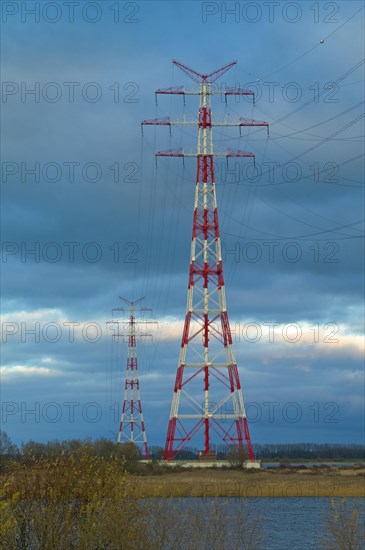 Red and white marked electricity pylons on the Lower Elbe near Stade