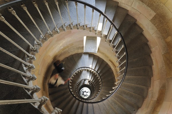 Tourists climbing spiral staircase inside the lighthouse Phare des Baleines on the island Ile de Re