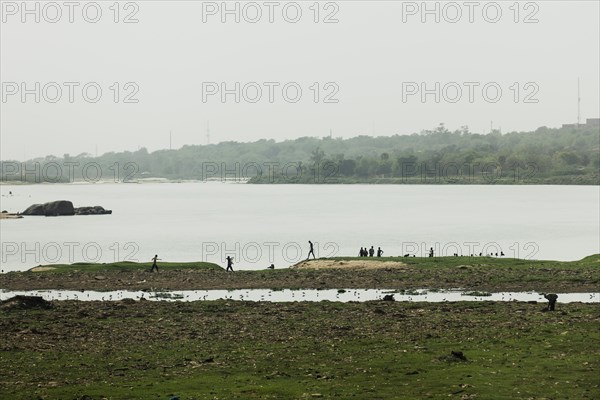 People silhouetted against the Niger River