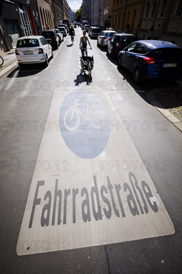 Symbolic photo on the subject of bicycle lanes in the city. Cyclists ride on the bicycle street in Linienstrasse in Berlin Mitte. Berlin