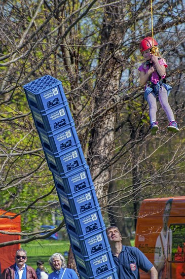 Child secured by rope falls while building tower out of beer crates