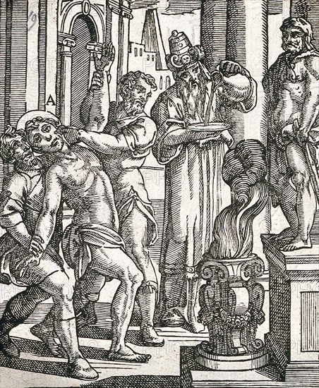A torture victim is about to have his hand put into an open flame while a priest looks on