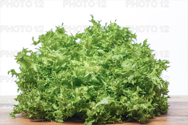 Curly endive isolated on white background on a wooden table