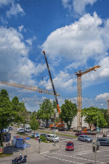 A construction crane is erected with a truck-mounted crane