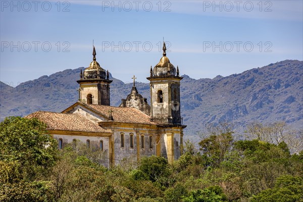 View from behind an old colonial-style church in the historic city of Ouro Preto in Minas Gerais and its mountains