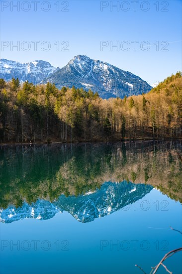 View over the green lake with mountain in the background