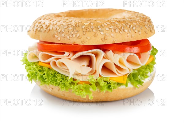 Bagel sandwich for breakfast topped with chicken and ham in front of a white background in Stuttgart