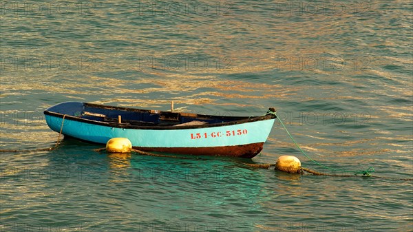 Turquoise small fishing boat